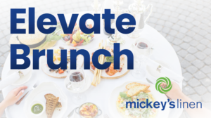Blog header image for the "Elevate Brunch" blog. Shows round table with a variety of brunch offferings along with the hands of two diners.